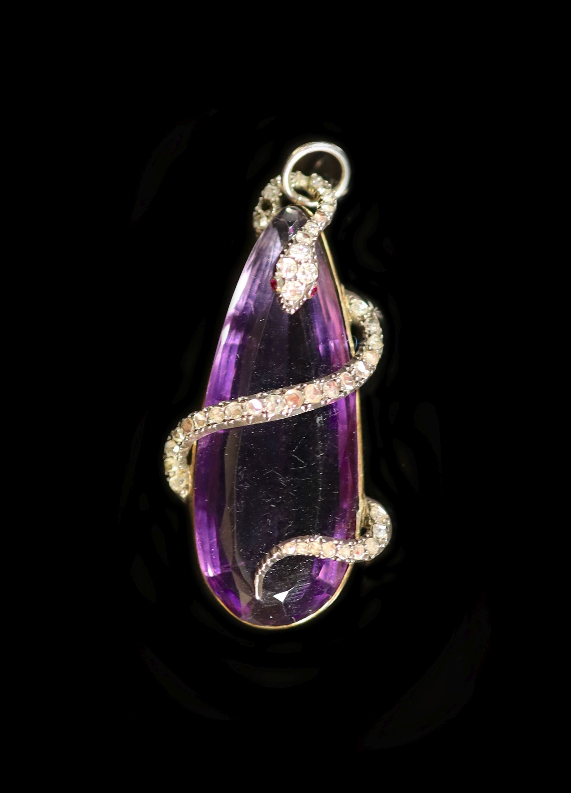 A Victorian gold mounted pear shaped amethyst pendant, entwined with diamond and ruby set serpent